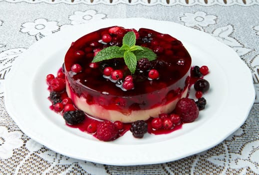 A  fruits tart on a glass cake stand