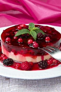 A  fruits tart on a glass cake stand