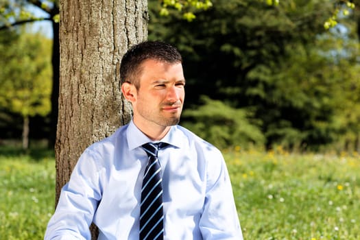 young businessman alone in nature in summer