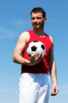 man with ball and blue sky in summer