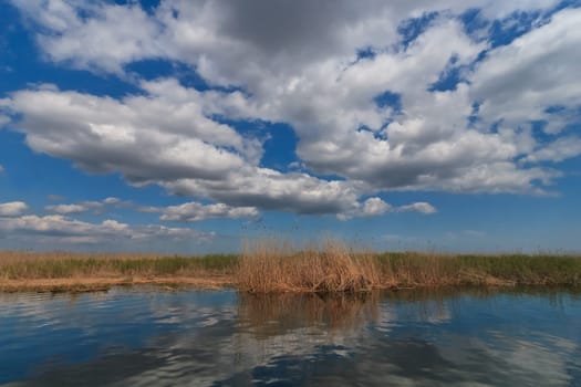 lake and clouds on a beautiful blue sky