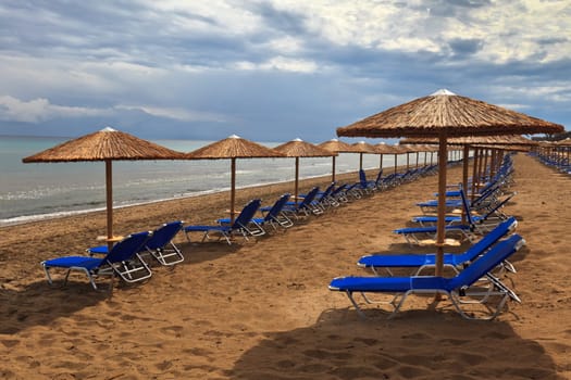 a beach filled with sun beds in Zakynthos, Greece