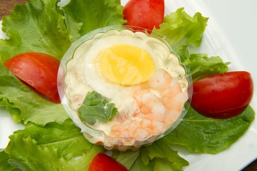 aspic with shrimps and eggs on fresh salad