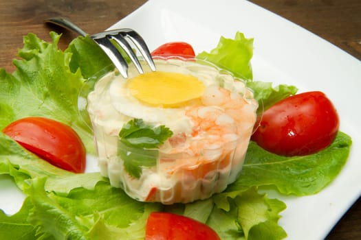 aspic with shrimps and eggs on fresh salad