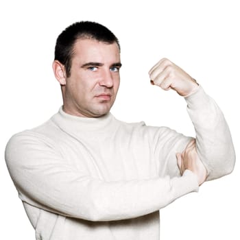 Portrait of a unhappy man flexing biceps in studio on white isolated background
