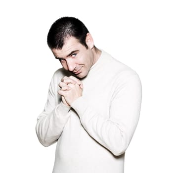 Portrait of a handsome amusing man with clasped hand in studio on white isolated background