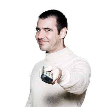 Portrait of an amusing mature man holding remote control in studio on white isolated background