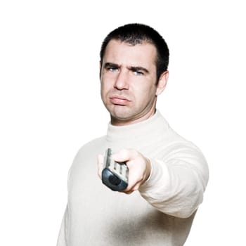 Portrait of an expressive bored man holding remote control in studio on white isolated background