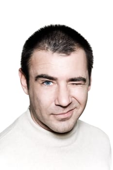 Portrait of a mischievous man winking on white isolated background