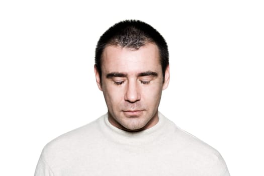 Portrait of a handsome expressive man meditating in studio on white isolated background