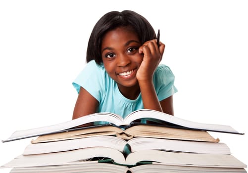 Beautiful happy smiling student with pen and a pile of open books doing homework, isolated.