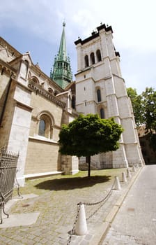 South facade of protestant Saint-Peter&#039 s cathedral with its green bell-tower in Geneva, Switzerland. The construction started in 1160 and lasted about one century. After that, it&#039 s been modified several times, sometimes because of fire. At XVI c