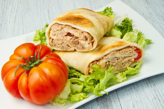 tuna sandwich on fresh salad and tomato