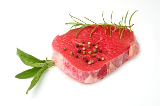 a red meat with sage and rosemary isolated on white background