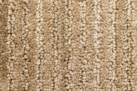 Close-up of a somewhat variegated brown tan carpet.