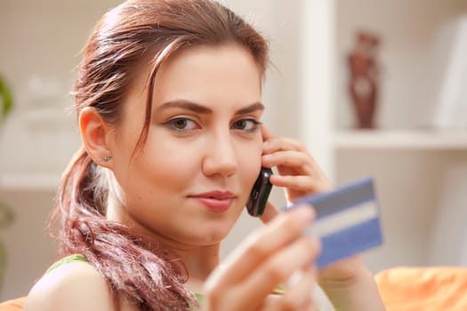 young woman with credit card and mobile phone