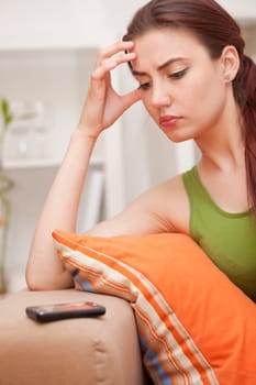 young woman waiting for a phone call at home