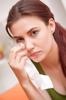 sad crying woman with handkerchief at home