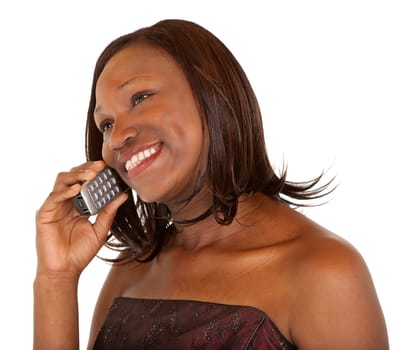 An African American woman is talking to her telephone.