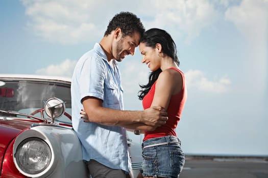 boyfriend and girlfriend leaning on vintage car and hugging in havana, cuba. Horizontal shape, side view, copy space