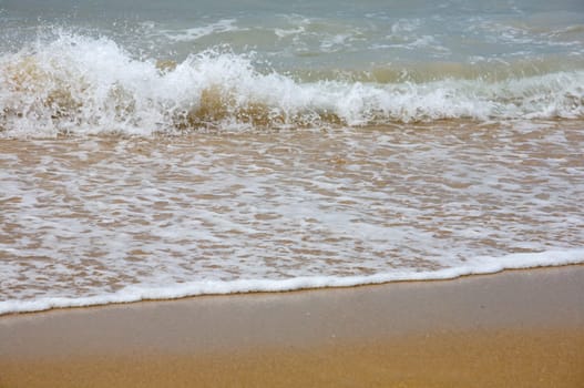 Waves breaking on shore of the sea