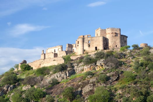 Beautiful landscape with a castle on a hill and a blue sky