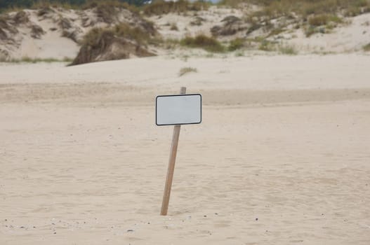 Lonely poster in the middle of the sand