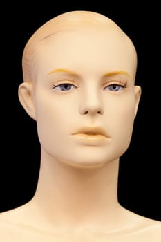 Face of a mannequin isolated on black background