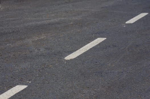 Road with white lines and asphalt texture