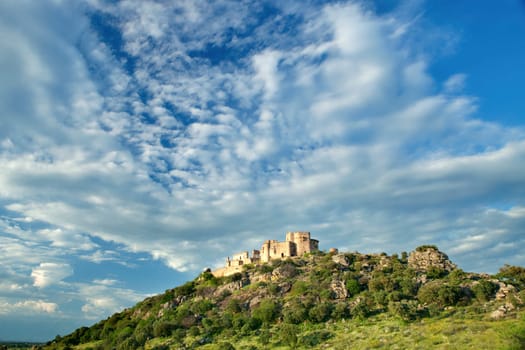 Beautiful landscape with a castle on a hill and a spectacular sky