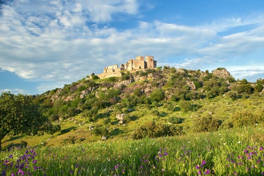 Beautiful landscape with a castle on a hill and a spectacular sky