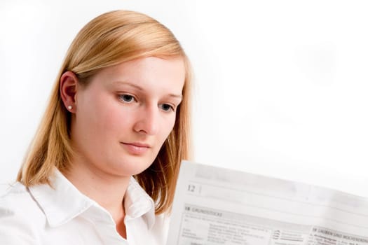 Young woman reading the newspaper