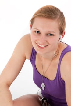 Young sporty woman listening to MP3 player