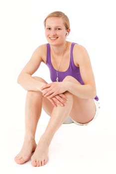 Young sporty woman listening to MP3 player