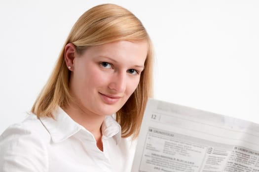 Young woman reading the newspaper