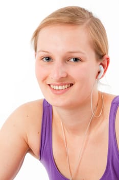 Young sporty woman listening to MP3 player