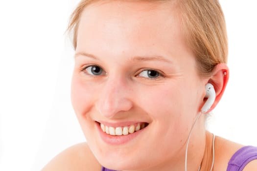 Young sporty woman listening to MP3 player