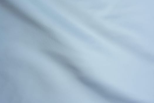 Close-up of white fabric with delicate folds, creating a minimalistic and elegant background suitable for design, textiles, and artistic projects.