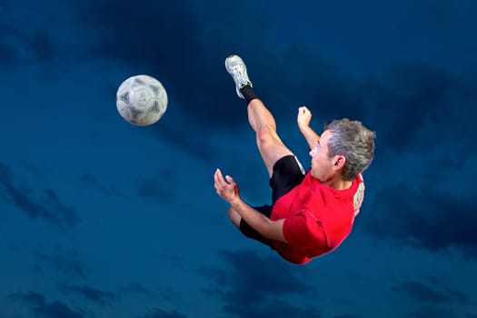 Footballers taking a overhead kick