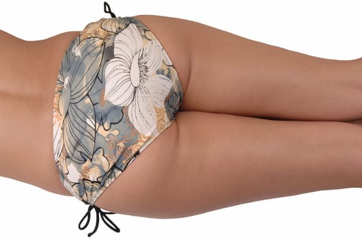 A young woman lying on the floor, showing her nice bottom in close upin beige bikini bottom for white background.
