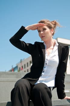 Young attractive business woman looking to future