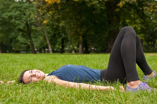 Enjoying life - woman lying in grass
