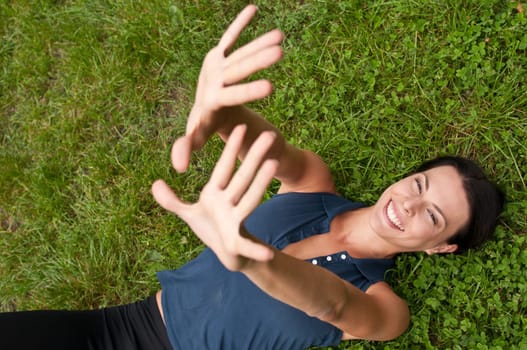 Happiness - woman lying in grass