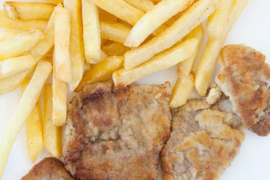 Chips and cooked pork fillets. Example of fast food