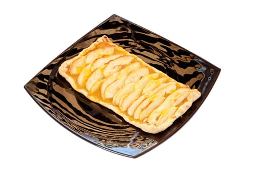 Delicious apple pie on a black plate isolated over white