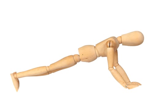 Jointed wooden mannequin doing push-ups isolated on white background