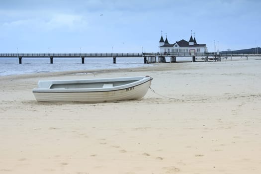 Fishing boat on the beach in front of the pier of Ahlbeck,Usedom Island,Mecklenburg-Western Pomerania,Germany