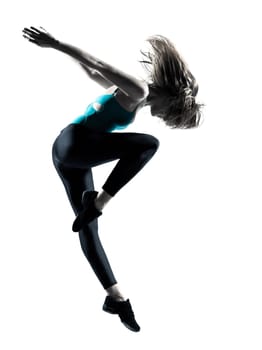Side view of a beautiful young female dancer showing her dancing skills on white background