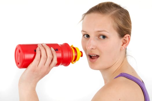 Young woman drinking from a drinking bottle