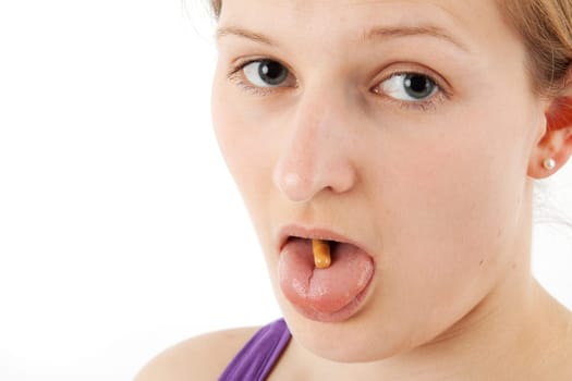Young woman swallowing capsule